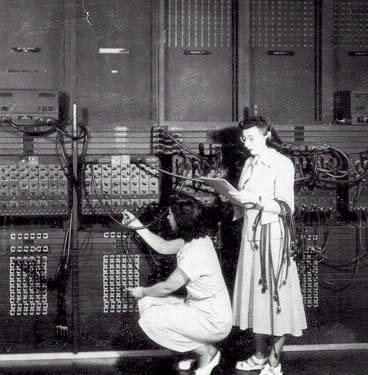 Two women wiring the right side of the ENIAC with a new program (U.S. Army photo, from archives of the ARL Technical Library, courtesy of Mike Muuss).